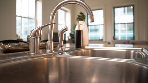 a stainless steel kitchen sink with two faucets at Market Square Place, Pennsylvania